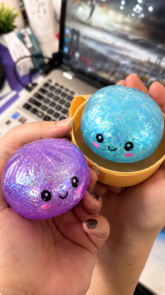 Customer holding blue and purple glitter dumpling squishies